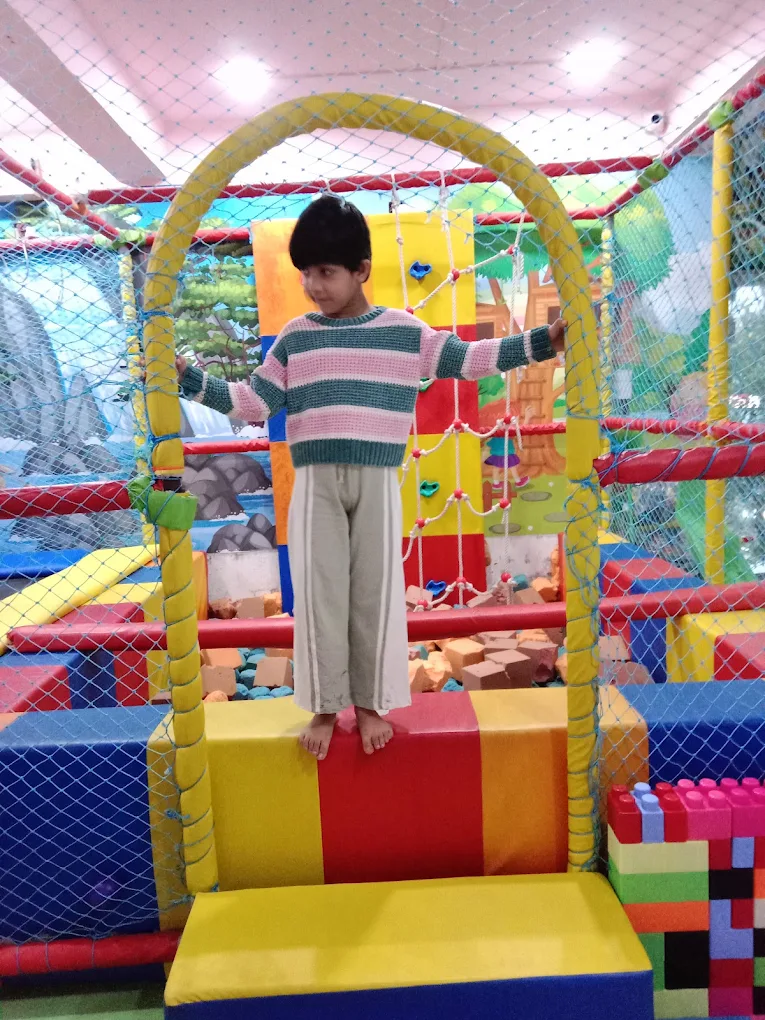 Child playing in indoor soft play structure